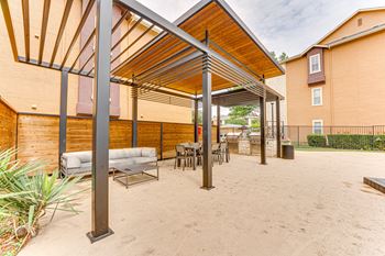 Covered outdoor lounge area with seating and dining space